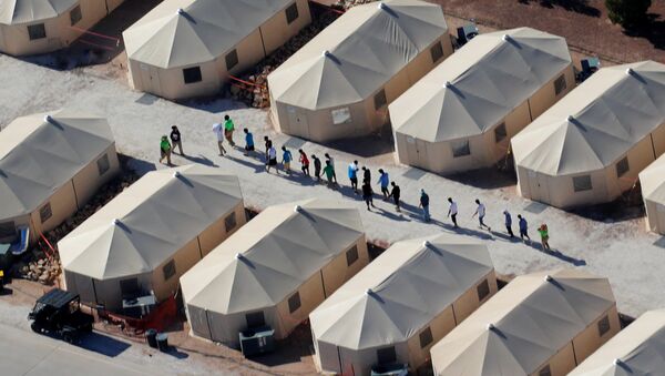Immigrant children now housed in a tent encampment under the new zero tolerance policy by the Trump administration are shown walking in single file at the facility near the Mexican border in Tornillo, Texas, U.S. June 19, 2018 - Sputnik International