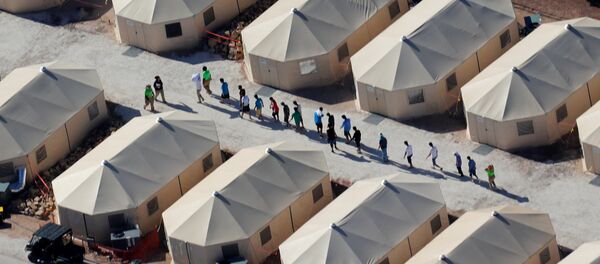 Immigrant children now housed in a tent encampment under the new zero tolerance policy by the Trump administration are shown walking in single file at the facility near the Mexican border in Tornillo, Texas, U.S. June 19, 2018 Immigrant children now housed in a tent encampment under the new zero tolerance policy by the Trump administration are shown walking in single file at the facility near the Mexican border in Tornillo, Texas, U.S. June 19, 2018 - Sputnik International