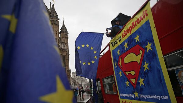 (File) Anti-Brexit demonstrators wave European Union flags from the top deck of a bus parked outside the Houses of Parliament in London on March 29, 2018 - Sputnik International