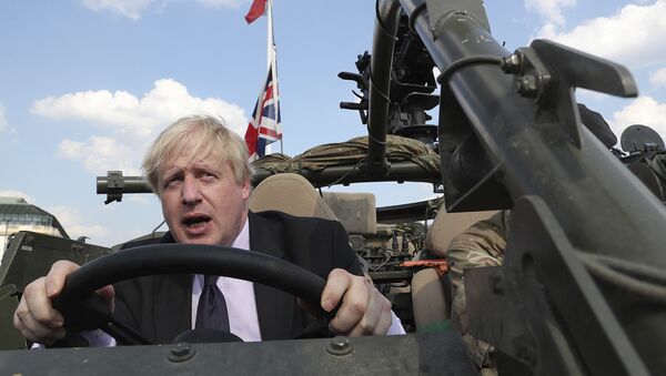 Britain's Foreign Secretary Boris Johnson talks to a British armed forces serviceman based in Orzysz, in northeastern Poland, during a ceremony at the Tomb of the Unknown Soldier and following talks on security with his Polish counterpart Jacek Czaputowicz in Warsaw, Poland, Thursday, June 21, 2018 - Sputnik International