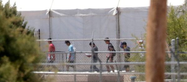 Detainees are seen outside tent shelters used to hold separated family members, Friday, June 22, in Fabens, Texas. The U.N human rights office says President Donald Trump's decision to stop the U.S. policy separating migrant parents from their children doesn't go far enough - Sputnik International