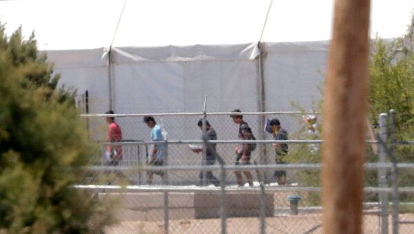 Detainees are seen outside tent shelters used to hold separated family members, Friday, June 22, in Fabens, Texas. The U.N human rights office says President Donald Trump's decision to stop the U.S. policy separating migrant parents from their children doesn't go far enough - Sputnik International