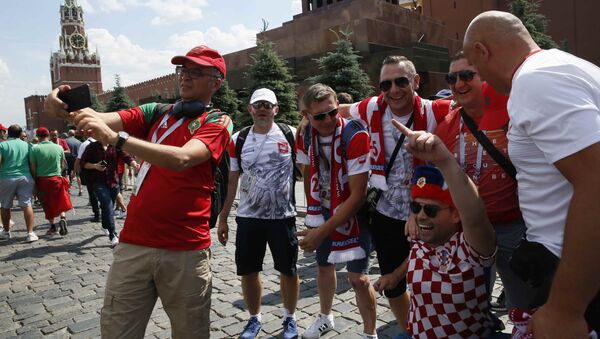 Soccer Football - World Cup - Group H - Poland vs Senegal - Moscow, Russia - June 19, 2018 Soccer fans cheer at the Red Square before the match - Sputnik International