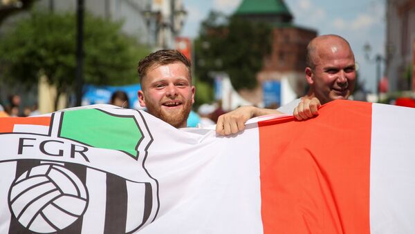 Soccer Football - FIFA World Cup - Group G - England v Panama - Nizhny Novgorod, Russia - June 24, 2018 - Supporters of England soccer team carry a flag as they gather for a match - Sputnik International
