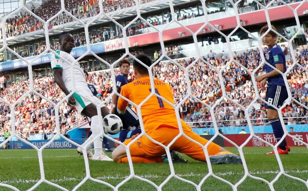 Soccer Football - World Cup - Group H - Japan vs Senegal - Ekaterinburg Arena, Yekaterinburg, Russia - June 24, 2018 Senegal's Sadio Mane scores their first goal past Japan's Eiji Kawashima Soccer Football - World Cup - Group H - Japan vs Senegal - Ekaterinburg Arena, Yekaterinburg, Russia - June 24, 2018 Senegal's Sadio Mane scores their first goal past Japan's Eiji Kawashima - Sputnik International
