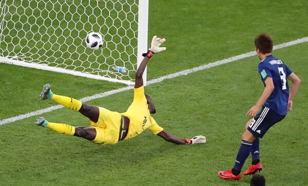 Soccer Football - World Cup - Group H - Japan vs Senegal - Ekaterinburg Arena, Yekaterinburg, Russia - June 24, 2018 Senegal's Khadim N'Diaye is beaten as Japan's Takashi Inui (not pictured) scores their first goal - Sputnik International