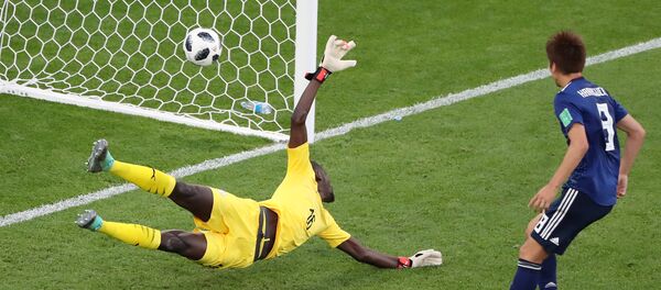 Soccer Football - World Cup - Group H - Japan vs Senegal - Ekaterinburg Arena, Yekaterinburg, Russia - June 24, 2018 Senegal's Khadim N'Diaye is beaten as Japan's Takashi Inui (not pictured) scores their first goal - Sputnik International