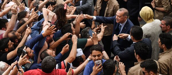 Turkey's President Recep Tayyip Erdogan, leader of the Justice and Development Party (AKP) and his wife Emine are greeted by supporters as they leave the polling station after casting their votes during snap twin Turkish presidential and parliamentary elections in Istanbul on June 24, 2018 Turkey's President Recep Tayyip Erdogan, leader of the Justice and Development Party (AKP) and his wife Emine are greeted by supporters as they leave the polling station after casting their votes during snap twin Turkish presidential and parliamentary elections in Istanbul on June 24, 2018 - Sputnik International