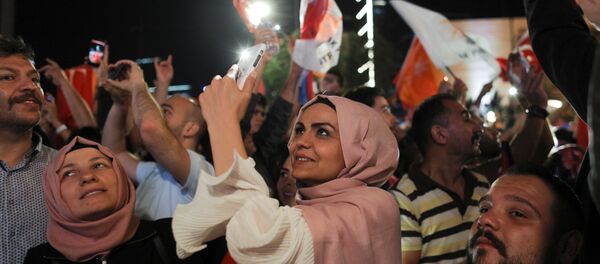 People take photographs as Turkish President Tayyip Erdogan (not pictured) addresses a speech at the AKP headquarters in Ankara, Turkey June 25, 2018 People take photographs as Turkish President Tayyip Erdogan (not pictured) addresses a speech at the AKP headquarters in Ankara, Turkey June 25, 2018 - Sputnik International