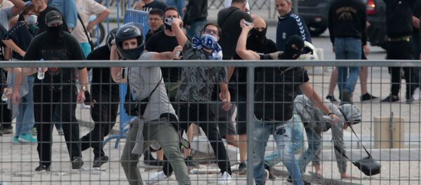 Protesters throw stones during clashes with riot police in a protest against the agreement reached by Greece and Macedonia to resolve a dispute over the former Yugoslav republic's name, in Thessaloniki, Greece, June 25, 2018 Protesters throw stones during clashes with riot police in a protest against the agreement reached by Greece and Macedonia to resolve a dispute over the former Yugoslav republic's name, in Thessaloniki, Greece, June 25, 2018 - Sputnik International