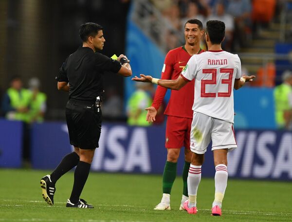Referee Enrique Caceres shows a yellow card to Portugal's Cristiano Ronaldo during the World Cup Group B soccer match between Iran and Portugal at the Mordovia Arena, in Saransk, Russia, June 25, 2018. Referee Enrique Caceres shows a yellow card to Portugal's Cristiano Ronaldo during the World Cup Group B soccer match between Iran and Portugal at the Mordovia Arena, in Saransk, Russia, June 25, 2018. - Sputnik International