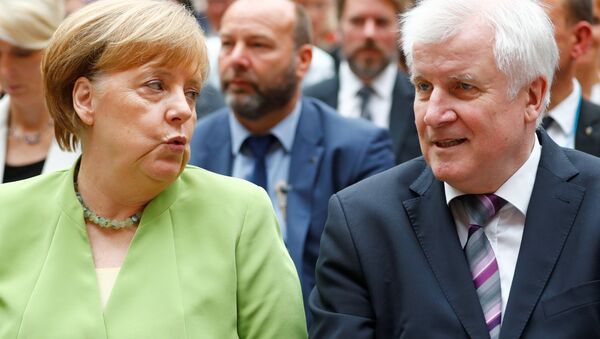 German Chancellor Angela Merkel and German Interior minister Horst Seehofer attend an event to commemorate victims of displacement in Berlin, Germany, June 20 2018 - Sputnik International