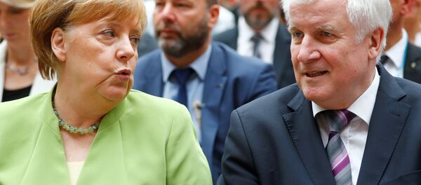 German Chancellor Angela Merkel and German Interior minister Horst Seehofer attend an event to commemorate victims of displacement in Berlin, Germany, June 20 2018 - Sputnik International