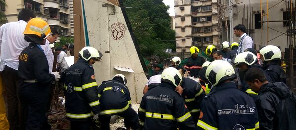 Firefighters inspect the sight of a plane crash in Mumbai, India June 28, 2018 Firefighters inspect the sight of a plane crash in Mumbai, India June 28, 2018 - Sputnik International
