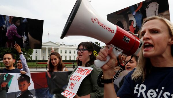 (File) Maggie Thompson from Generation Progress, right, leads protest chants against the Trump administration's immigration policy that results in the separation of children from their parents at the southern border of the U.S. outside of the White House in Washington, U.S., June 21, 2018 - Sputnik International