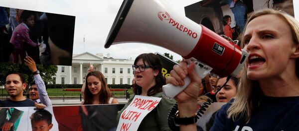 (File) Maggie Thompson from Generation Progress, right, leads protest chants against the Trump administration's immigration policy that results in the separation of children from their parents at the southern border of the U.S. outside of the White House in Washington, U.S., June 21, 2018 - Sputnik International