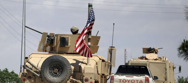 The U.S. flag flutters on a military vehicle in Manbij countryside, Syria May 12, 2018 - Sputnik International