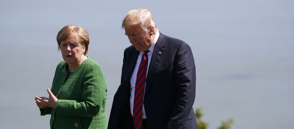 President Donald Trump, right, talks with German Chancellor Angela Merkel after the family photo during the G7 Summit, Friday, June 8, 2018, in Charlevoix, Canada - Sputnik International