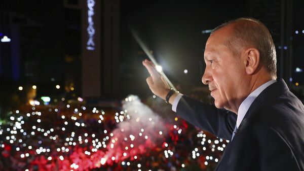 Turkey's President Recep Tayyip Erdogan, waves to supporters of his ruling Justice and Development Party (AKP) in Ankara, Turkey, early Monday, June 25, 2018. Erdogan won Turkey's landmark election Sunday, the country's electoral commission said, ushering in a new system granting the president sweeping new powers which critics say will cement what they call a one-man rule - Sputnik International