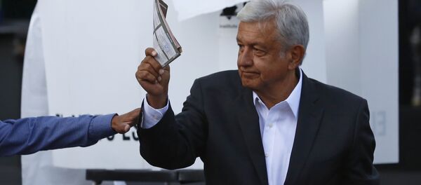 Presidential candidate Andres Manuel Lopez Obrador, of the MORENA party, shows his ballot to the press before casting it during general elections in Mexico City, Sunday, July 1, 2018. Sunday’s elections for posts at every level of government are Mexico’s largest ever and have become a referendum on corruption, graft and other tricks used to divert taxpayer money to officials’ pockets and empty those of the country’s poor Presidential candidate Andres Manuel Lopez Obrador, of the MORENA party, shows his ballot to the press before casting it during general elections in Mexico City, Sunday, July 1, 2018. Sunday’s elections for posts at every level of government are Mexico’s largest ever and have become a referendum on corruption, graft and other tricks used to divert taxpayer money to officials’ pockets and empty those of the country’s poor - Sputnik International