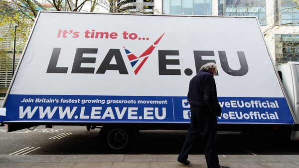 A man walks past a campaign poster ahead of a press briefing by the Leave.EU campaign group in central London on November 18, 2015 - Sputnik International