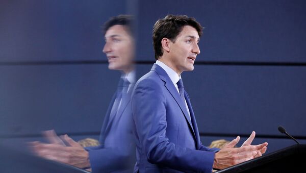 Canada's Prime Minister Justin Trudeau is reflected in a monitor while speaking during a news conference in Ottawa, Ontario, Canada, June 20, 2018 - Sputnik International