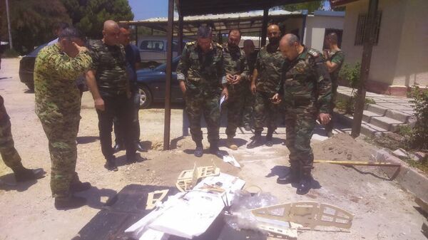 Syrian servicemen are seen near a downed drone Syrian servicemen are seen near a downed drone - Sputnik International