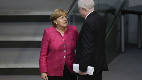 In this May 15, 2018 file photo German Chancellor Angela Merkel, left, talks with German Interior Minister Horst Seehofer, right, during the first day of the budget 2018 debate at the parliament Bundestag at the Reichstag building in Berlin - Sputnik International