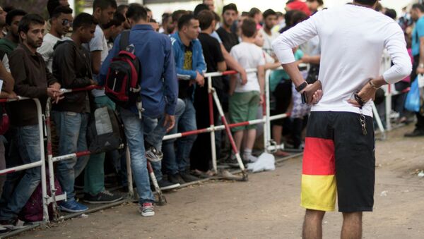 Newly arrived migrants wait in front of the State Office for Health and Social Affairs to apply for asylum in Berlin, Germany August 11, 2015 - Sputnik International