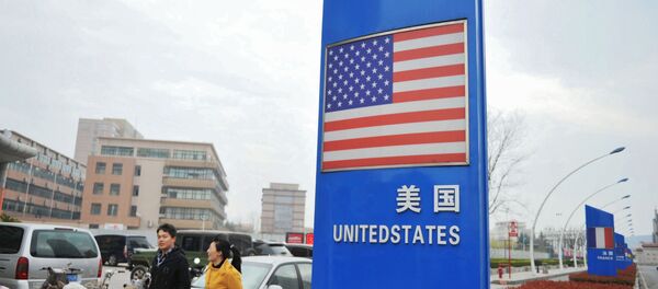 This file picture taken on April 5, 2018 shows a sign with a US flag outside a supermarket selling foreign goods in Qingdao, in China's eastern Shandong province This file picture taken on April 5, 2018 shows a sign with a US flag outside a supermarket selling foreign goods in Qingdao, in China's eastern Shandong province - Sputnik International