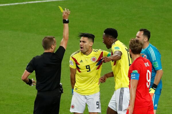 Soccer Football - World Cup - Round of 16 - Colombia vs England - Spartak Stadium, Moscow, Russia - July 3, 2018 Colombia's Radamel Falcao is shown a yellow card by referee Mark Geiger - Sputnik International