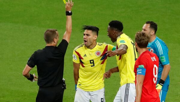 Soccer Football - World Cup - Round of 16 - Colombia vs England - Spartak Stadium, Moscow, Russia - July 3, 2018 Colombia's Radamel Falcao is shown a yellow card by referee Mark Geiger - Sputnik International