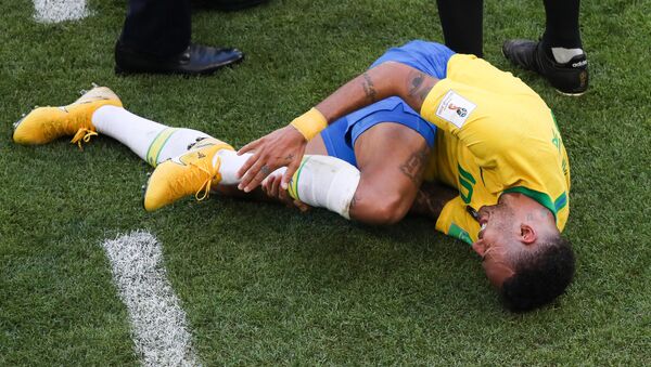 Brazil's Neymar lies on the ground suffering after a collision during the World Cup Round of 16 soccer match between Brazil and Mexico at the Samara Arena, in Samara, Russia, July 2, 2018 - Sputnik International