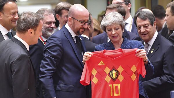 British Prime Minister Theresa May, center right, holds up a Belgian National team soccer jersey presented by Belgian Prime Minister Charles Michel, center left, during a round table meeting at an EU summit in Brussels, Thursday, June 28, 2018. - Sputnik International