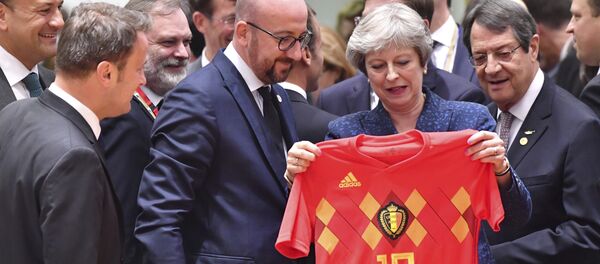 British Prime Minister Theresa May, center right, holds up a Belgian National team soccer jersey presented by Belgian Prime Minister Charles Michel, center left, during a round table meeting at an EU summit in Brussels, Thursday, June 28, 2018. British Prime Minister Theresa May, center right, holds up a Belgian National team soccer jersey presented by Belgian Prime Minister Charles Michel, center left, during a round table meeting at an EU summit in Brussels, Thursday, June 28, 2018. - Sputnik International