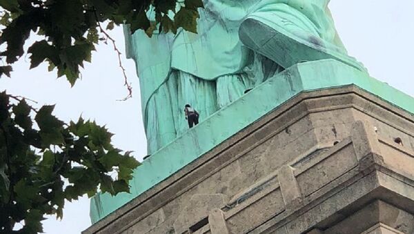 A protester is seen on the Statue of Liberty in New York, New York, U.S., July 4, 2018 in this picture obtained from social media - Sputnik International