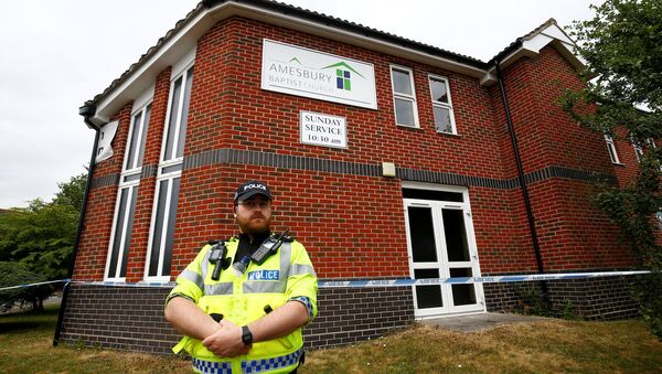 A police officer stands in front of Amesbury Baptist Church, which has been cordoned off after two people were hospitalised and police declared a 'major incident', in Amesbury, Wiltshire, Britain, July 4, 2018 - Sputnik International