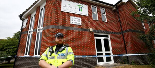 A police officer stands in front of Amesbury Baptist Church, which has been cordoned off after two people were hospitalised and police declared a 'major incident', in Amesbury, Wiltshire, Britain, July 4, 2018 - Sputnik International