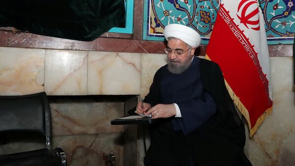 Iran's President Hassan Rouhani fills in his ballot - Sputnik International