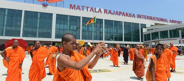 (File) A Sri Lankan Budhist monk takes pictures of an unseen Sri Lankan airlines Airbus A-340 which transported President Mahinda Rajapakse who became the first passenger to go through the facility, at the new Mattala Rajapaksa International Airport in Mattala, in the southeast of the island on March 18, 2013 (File) A Sri Lankan Budhist monk takes pictures of an unseen Sri Lankan airlines Airbus A-340 which transported President Mahinda Rajapakse who became the first passenger to go through the facility, at the new Mattala Rajapaksa International Airport in Mattala, in the southeast of the island on March 18, 2013 - Sputnik International