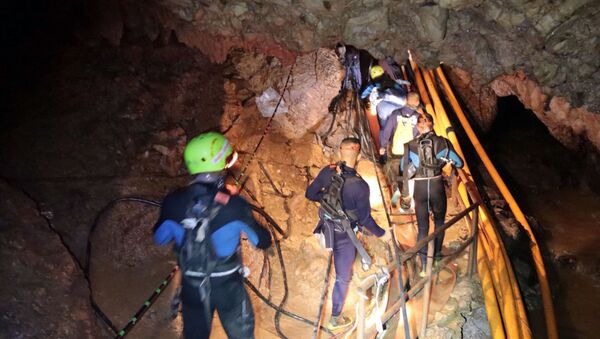 In this undated photo released by Royal Thai Navy on Saturday, July 7, 2018, Thai rescue team members walk inside a cave where 12 boys and their soccer coach have been trapped since June 23, in Mae Sai, Chiang Rai province, northern Thailand - Sputnik International