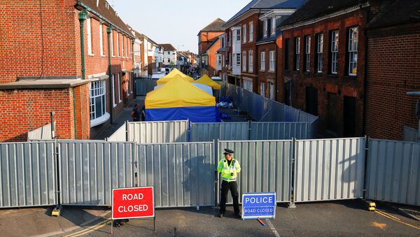 A police officer stands in front of screening erected behind John Baker House as forensic tents are erected, after it was confirmed that two people had been poisoned with the nerve-agent Novichok, in Amesbury, Britain - Sputnik International