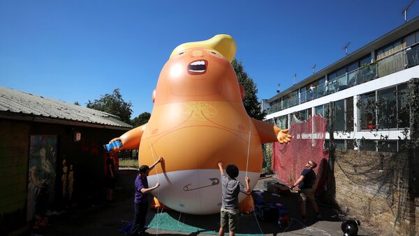 People inflate a helium filled Donald Trump blimp which they hope to deploy during The President of the United States' upcoming visit, in London, Britain, June 26, 2018 - Sputnik International