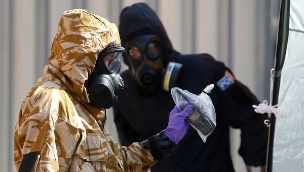Forensic investigators, wearing protective suits, emerge from the rear of John Baker House, after it was confirmed that two people had been poisoned with the nerve-agent Novichok, in Amesbury, Britain, July 6, 2018 - Sputnik International