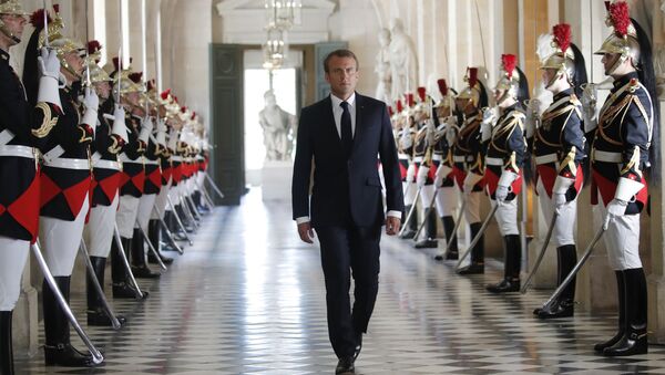 French President Emmanuel Macron walks through the Galerie des Bustes (Busts Gallery) to access Versailles' hemicycle to address both the upper and lower houses of the French parliament at a special session in Versailles, near Paris, 9 July 2018. - Sputnik International