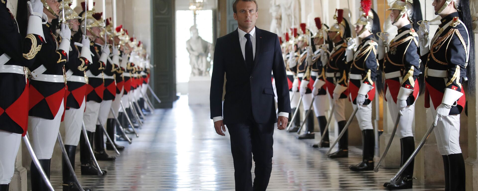 French President Emmanuel Macron walks through the Galerie des Bustes (Busts Gallery) to access the Versailles Palace's hemicycle to address both the upper and lower houses of the French parliament at a special session in Versailles, near Paris, Monday, July 9, 2018. - Sputnik International, 1920, 10.07.2024