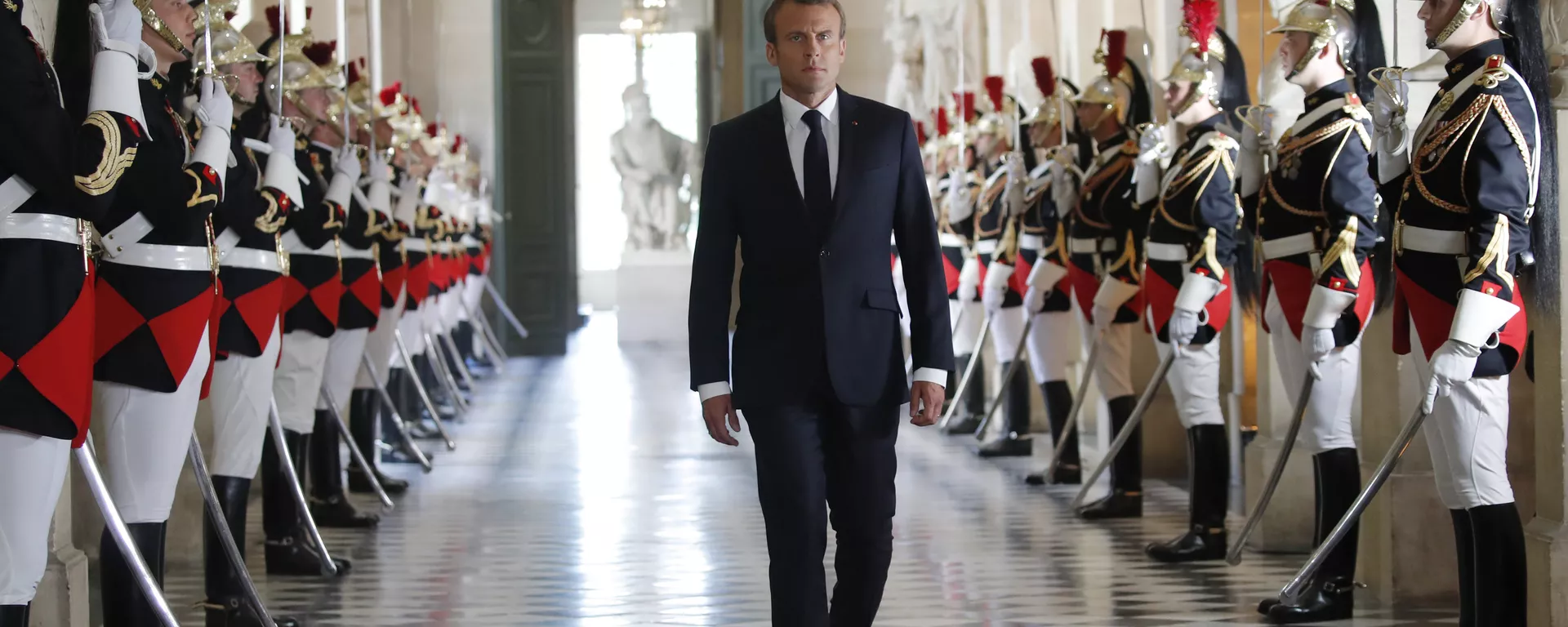 French President Emmanuel Macron walks through the Galerie des Bustes (Busts Gallery) to access the Versailles Palace's hemicycle to address both the upper and lower houses of the French parliament at a special session in Versailles, near Paris, Monday, July 9, 2018. - Sputnik International, 1920, 10.07.2024