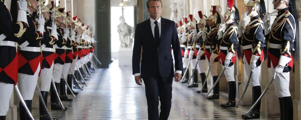 French President Emmanuel Macron walks through the Galerie des Bustes (Busts Gallery) to access Versailles' hemicycle to address both the upper and lower houses of the French parliament at a special session in Versailles, near Paris, 9 July 2018. - Sputnik International