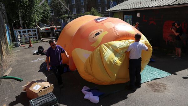 People inflate a helium filled Donald Trump blimp which they hope to deploy during The President of the United States' upcoming visit, in London, Britain, June 26, 2018 - Sputnik International