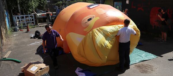 People inflate a helium filled Donald Trump blimp which they hope to deploy during The President of the United States' upcoming visit, in London, Britain, June 26, 2018 - Sputnik International
